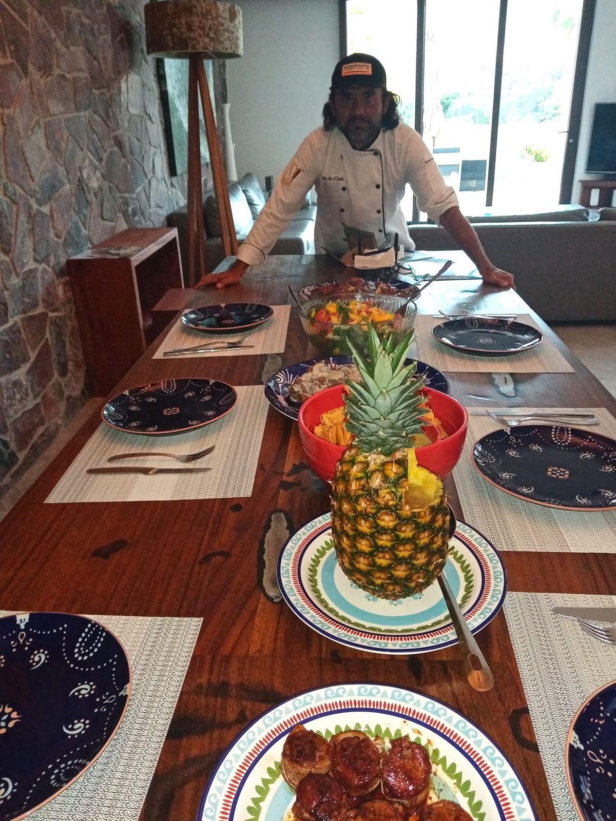 Chef Cabo Alex presenting a beautifully set private villa dinner table